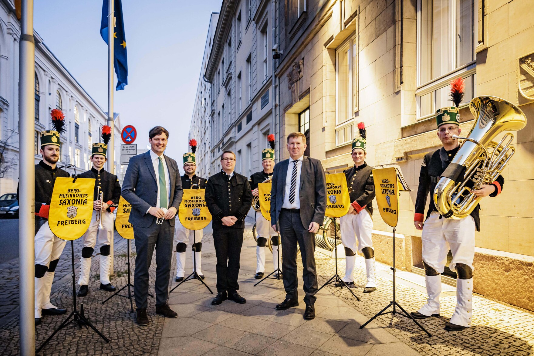 Mehrere Menschen laufen eine Straße entland.